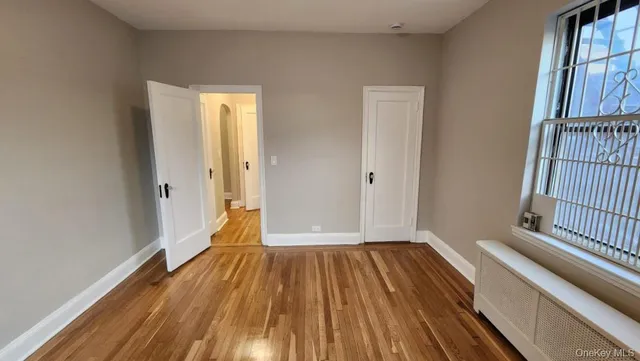 a view of a room with wooden floor and door