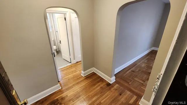 a view of front door with wooden floor