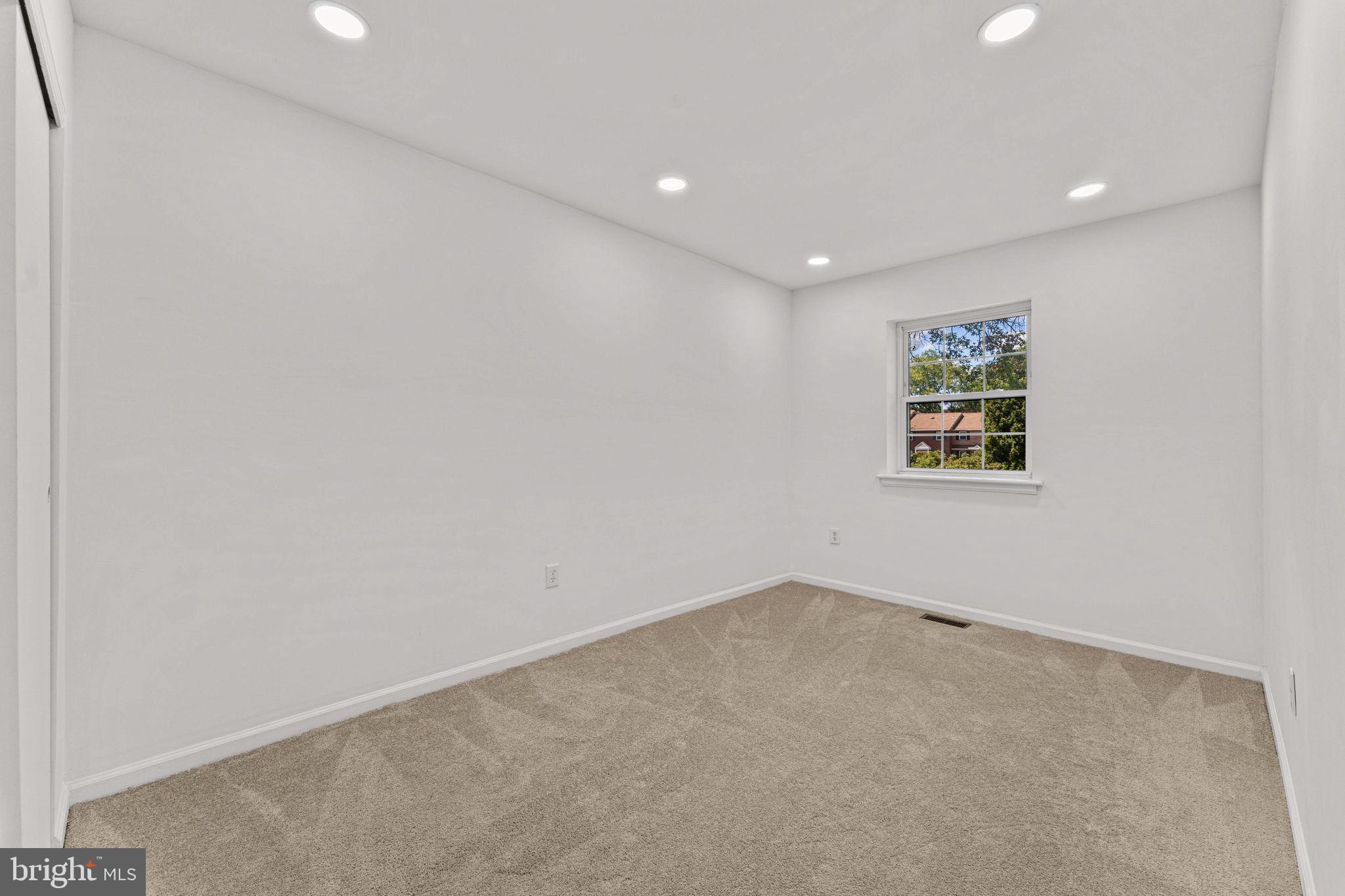 41 Zummo Way, Unit CONDO Norristown, PA 19401 - Photo 11 of 24 an empty room with a ceiling fan and window