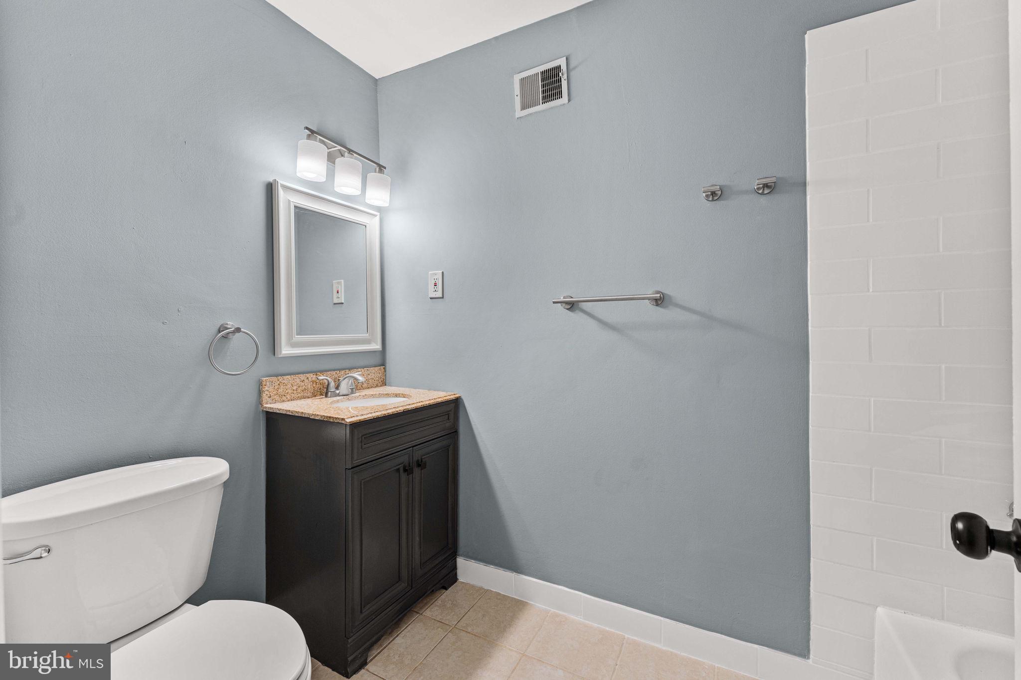41 Zummo Way, Unit CONDO Norristown, PA 19401 - Photo 16 of 24 a bathroom with a granite countertop toilet and a sink