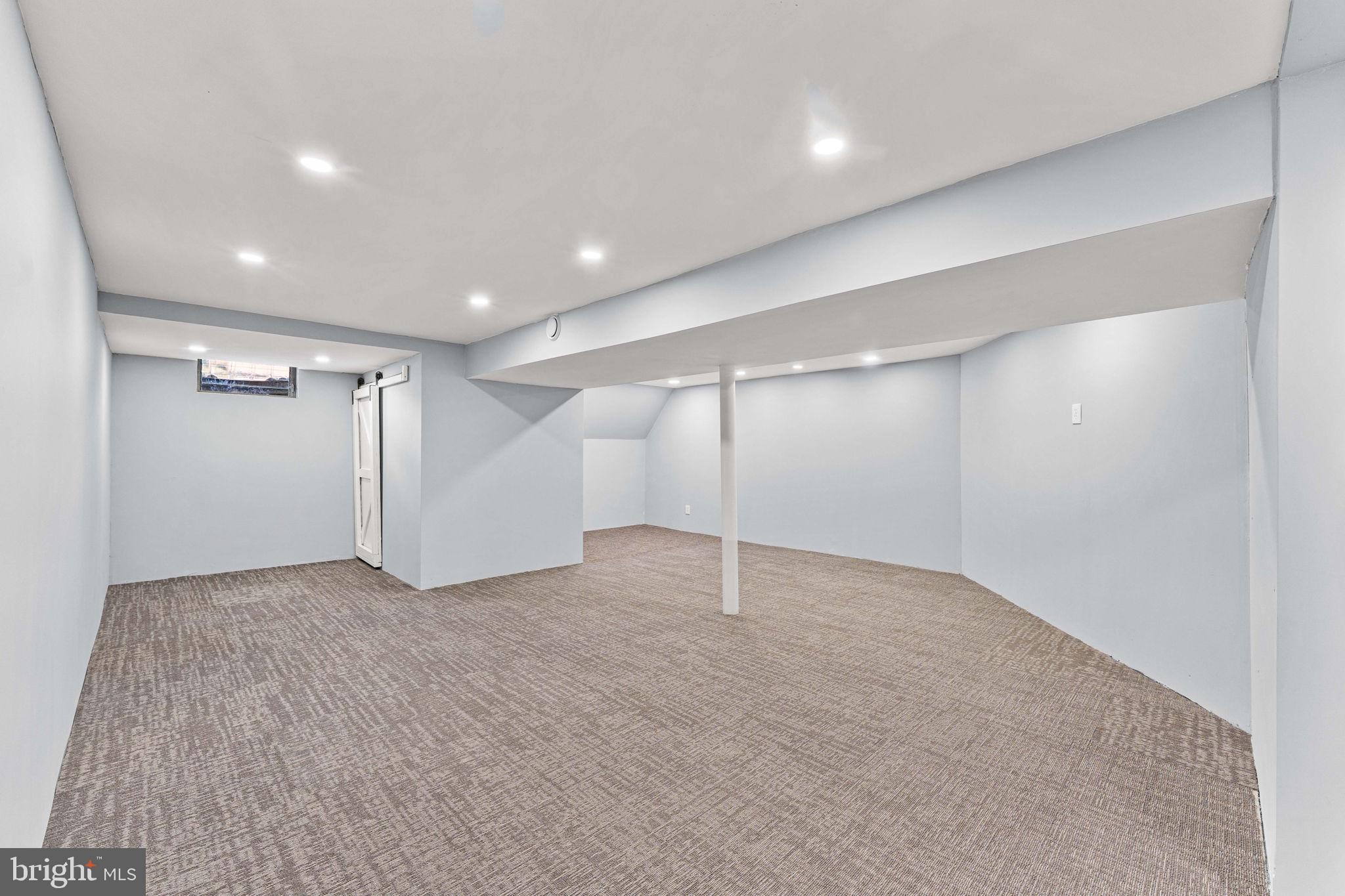 41 Zummo Way, Unit CONDO Norristown, PA 19401 - Photo 20 of 24 an empty room with a ceiling fan and windows