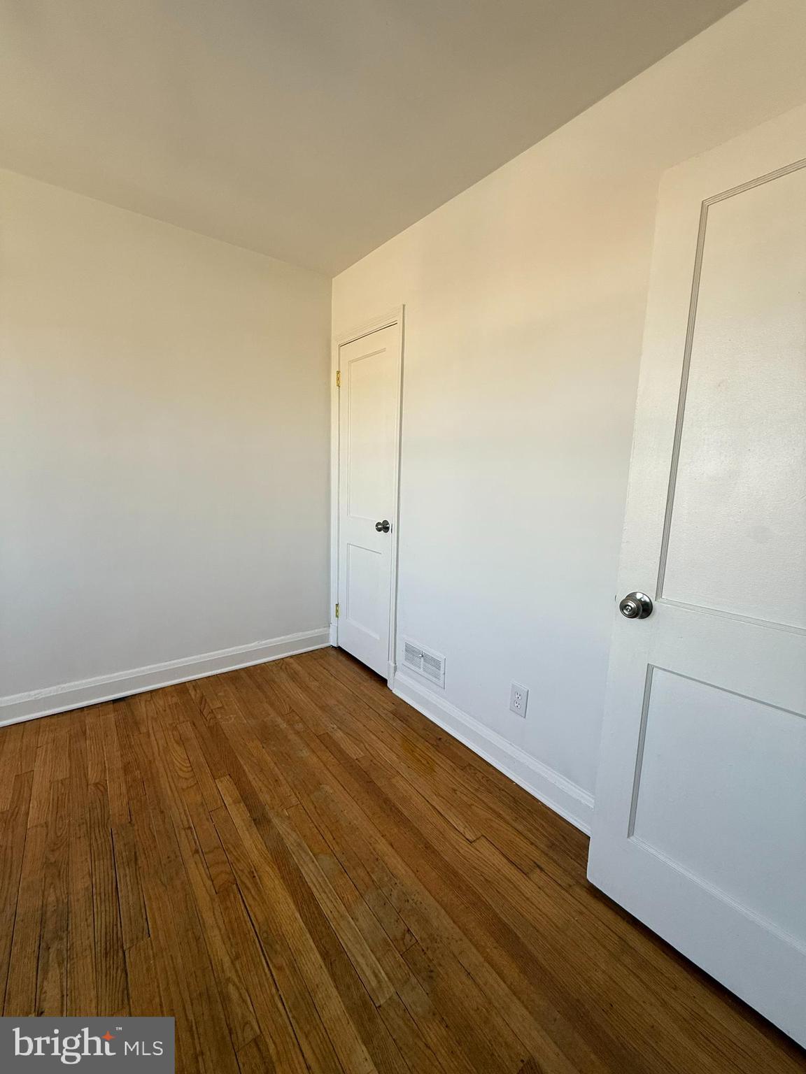 3731 Bonview Avenue, Unit 2B Baltimore, MD 21213 - Photo 13 of 14 an empty room with wooden floor