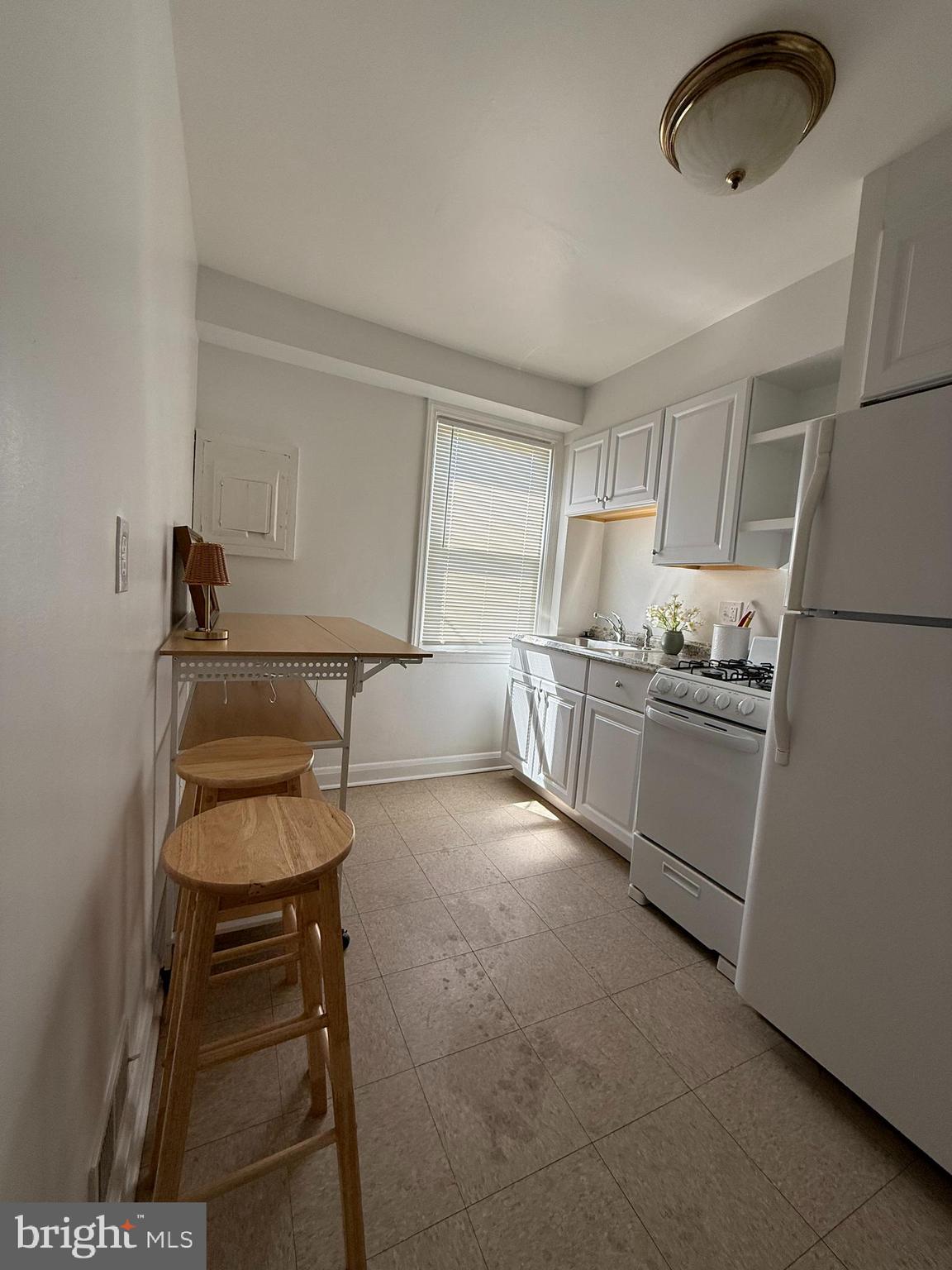 3731 Bonview Avenue, Unit 2B Baltimore, MD 21213 - Photo 2 of 14 a kitchen with granite countertop a sink cabinets stainless steel appliances and cabinets