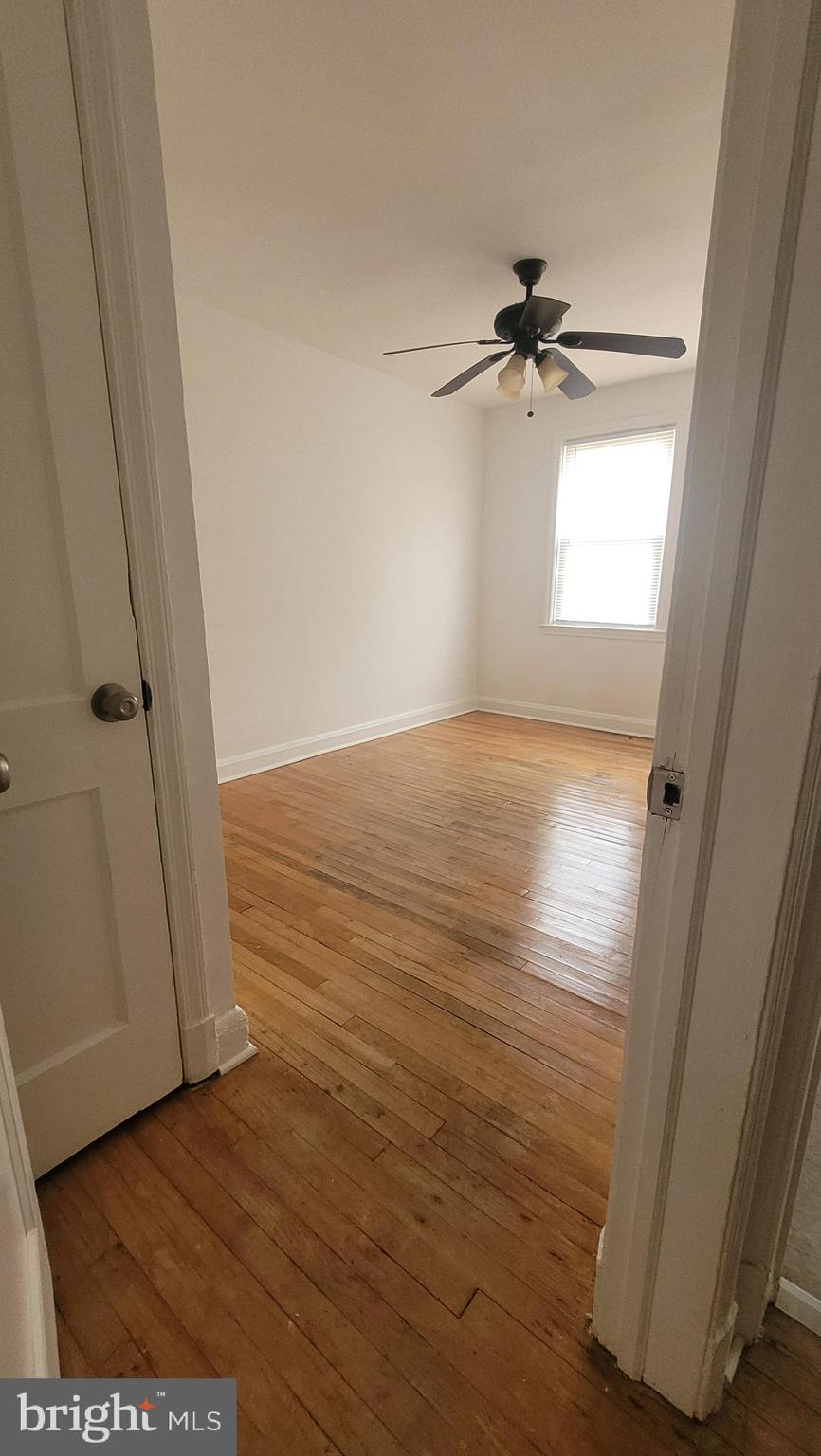 3731 Bonview Avenue, Unit 2B Baltimore, MD 21213 - Photo 8 of 14 wooden floor in an empty room with a window