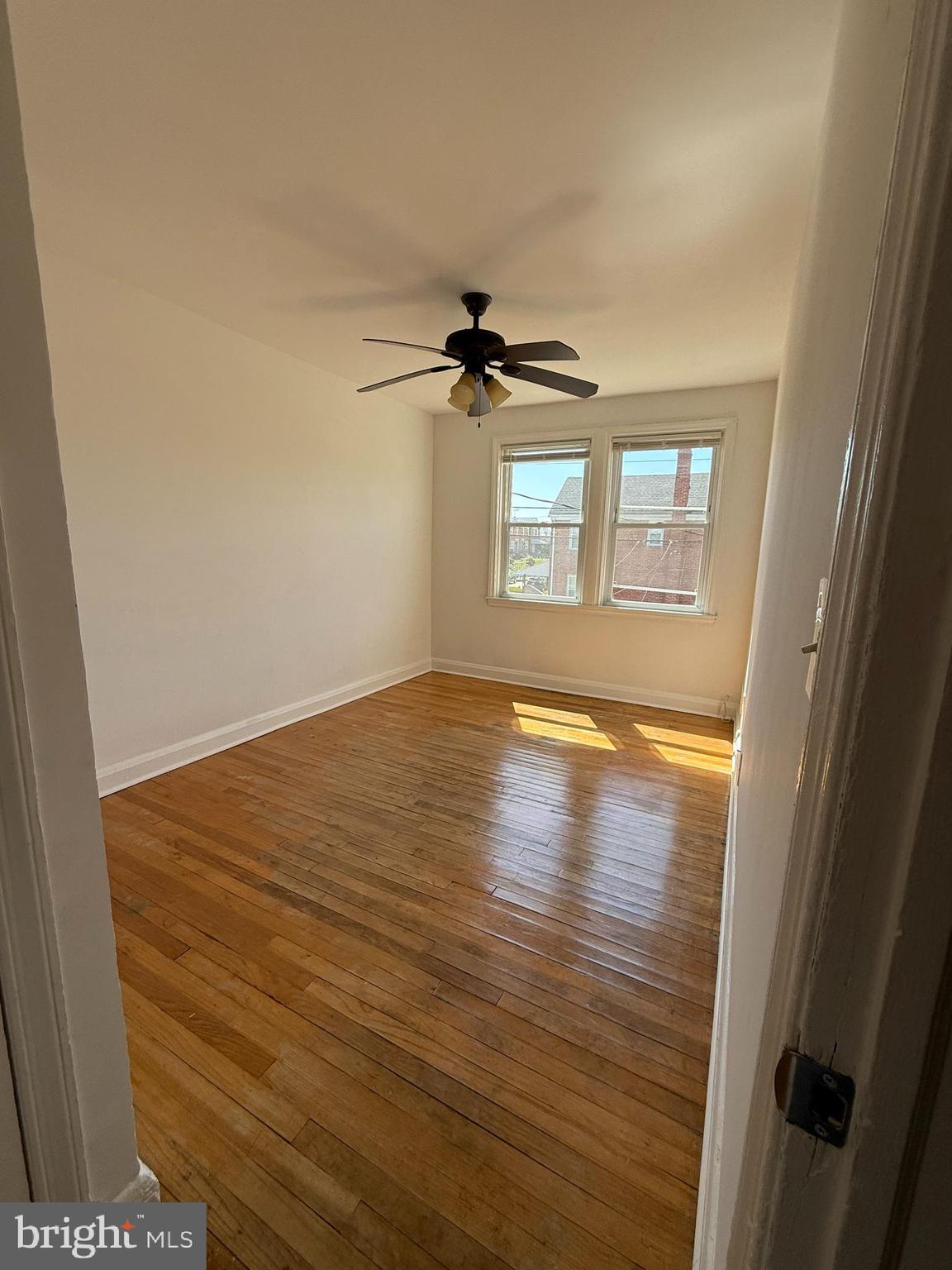 3731 Bonview Avenue, Unit 2B Baltimore, MD 21213 - Photo 10 of 14 wooden floor in an empty room with a window