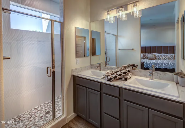 a bathroom with a double vanity sink and a mirror