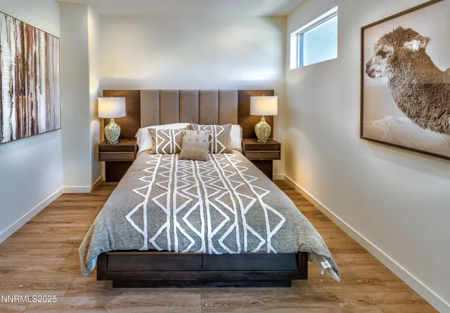 a view of bedroom with wooden floor