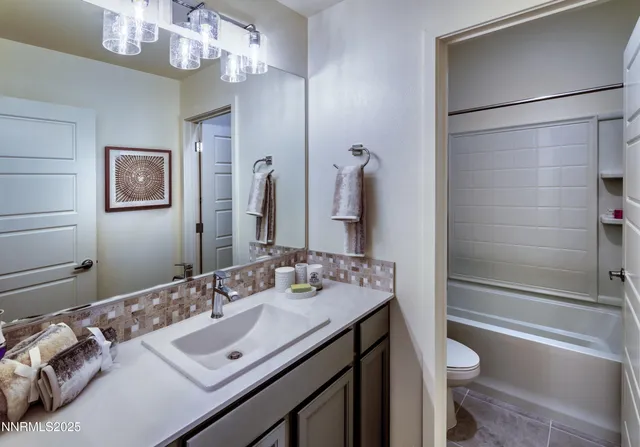 a bathroom with a sink double vanity granite tub and shower