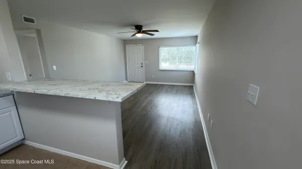a view of hallway with wooden floor