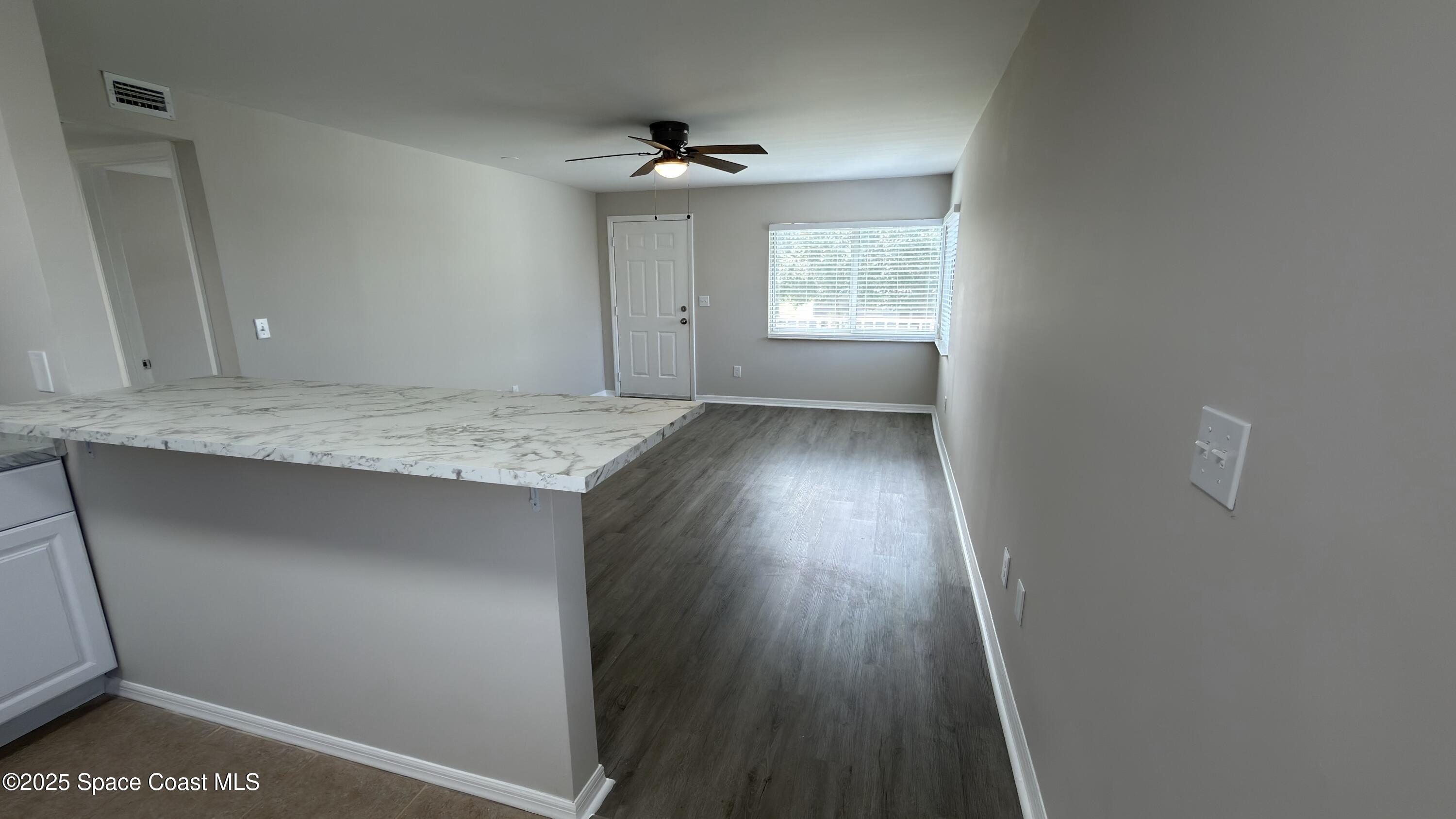 800 North Fiske Boulevard, Unit 709 Cocoa, FL 32922 - Photo 6 of 11 a view of hallway with wooden floor