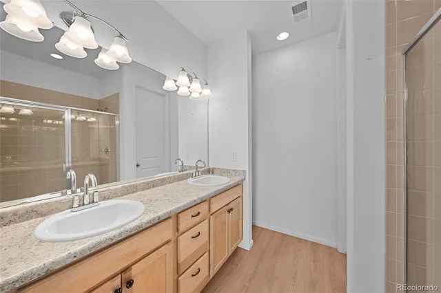 a view of a house with a big yard and large tree