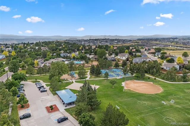 an aerial view of residential houses with outdoor space and street view