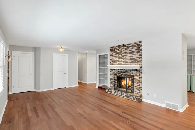 a kitchen with kitchen island granite countertop a sink cabinets and wooden floor