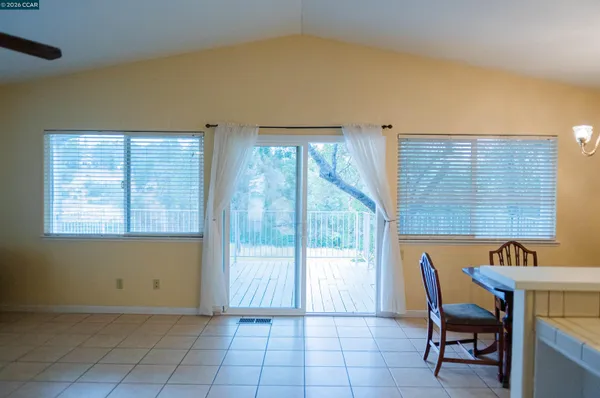 a view of a room that has a bed and a chair in it