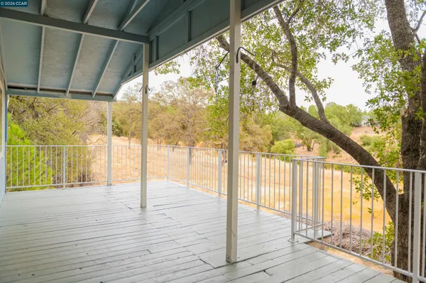 a view of porch with wooden floor and fence