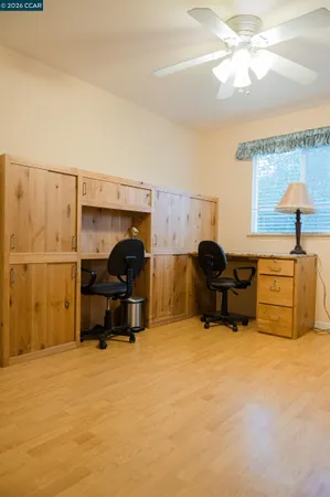 a living room with furniture a flat screen tv and a window