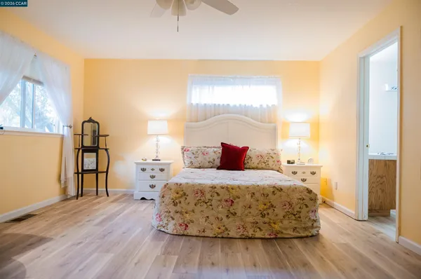 a bedroom with a bed and wooden floor