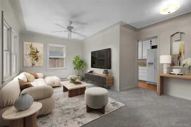 a living room with furniture a flat screen tv and a large window