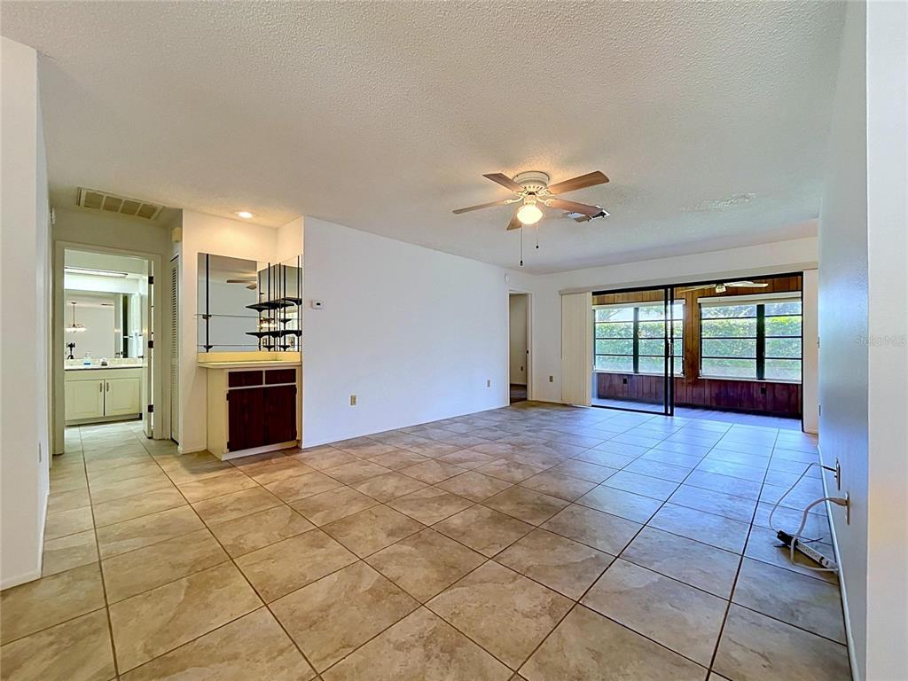 9319 Trowbridge Court New Port Richey, FL 34655 - Photo 15 of 78 a view of an empty room with a kitchen