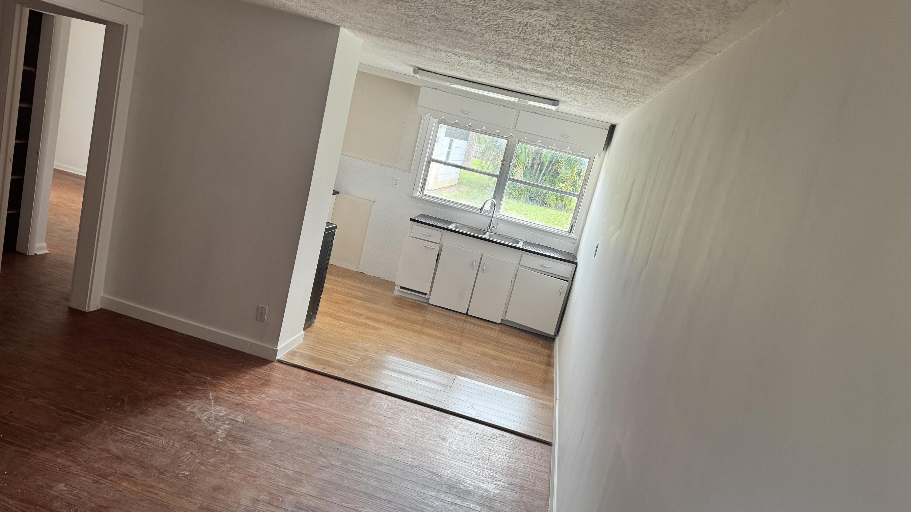 a view of an empty room and wooden floor