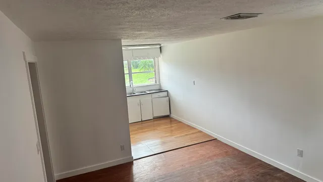 a view of an empty room and a window