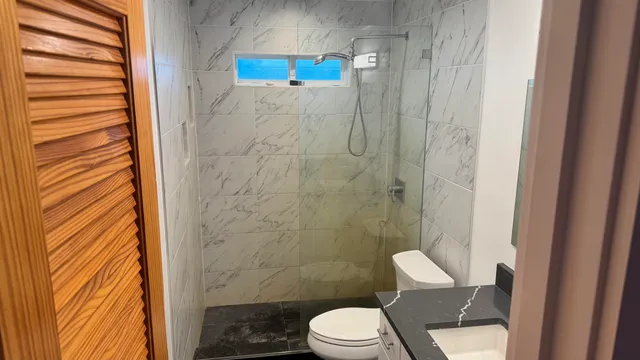 a white toilet sitting next to a shower curtain