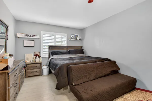 a bedroom with a bed and a window