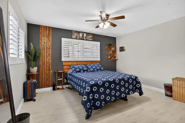 a bedroom with a bed and a chandelier