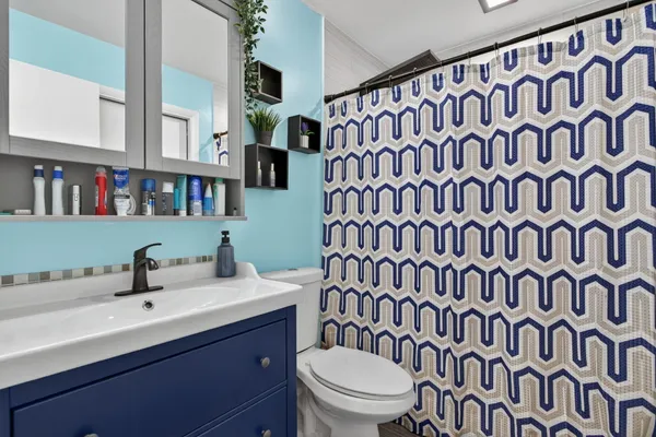 a bathroom with a sink toilet and a mirror