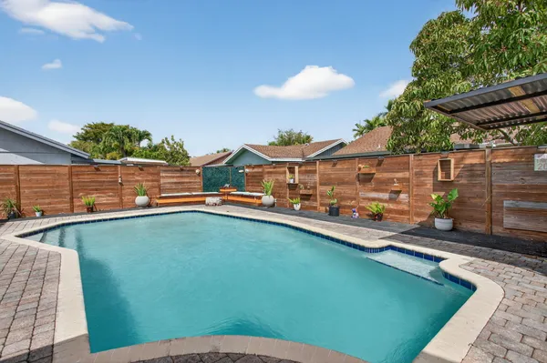 swimming pool view with a seating space
