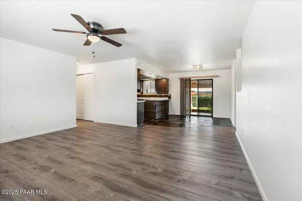 a view of empty room with wooden floor and fireplace