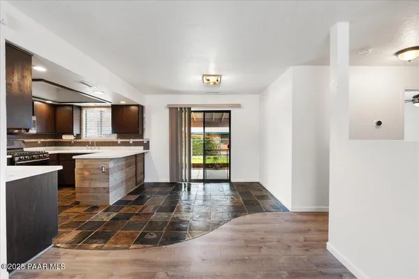 a kitchen with granite countertop a stove and a refrigerator