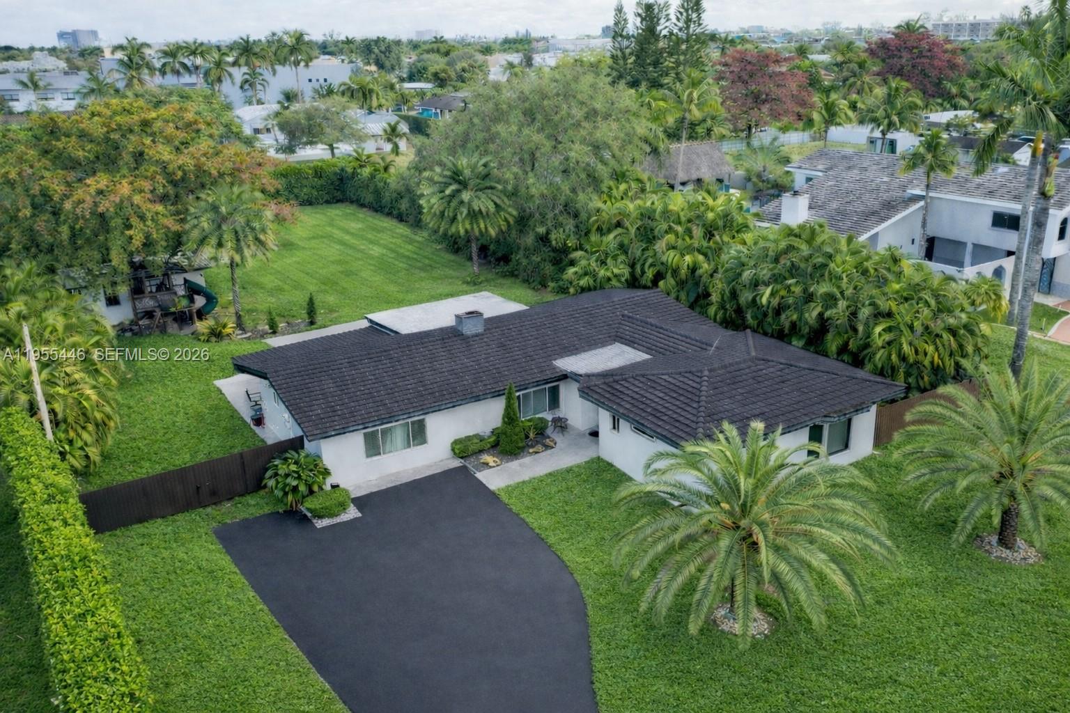 241 Southwest 129th Avenue Miami, FL 33184 - Photo 1 of 28 an aerial view of a house with a yard and lake view