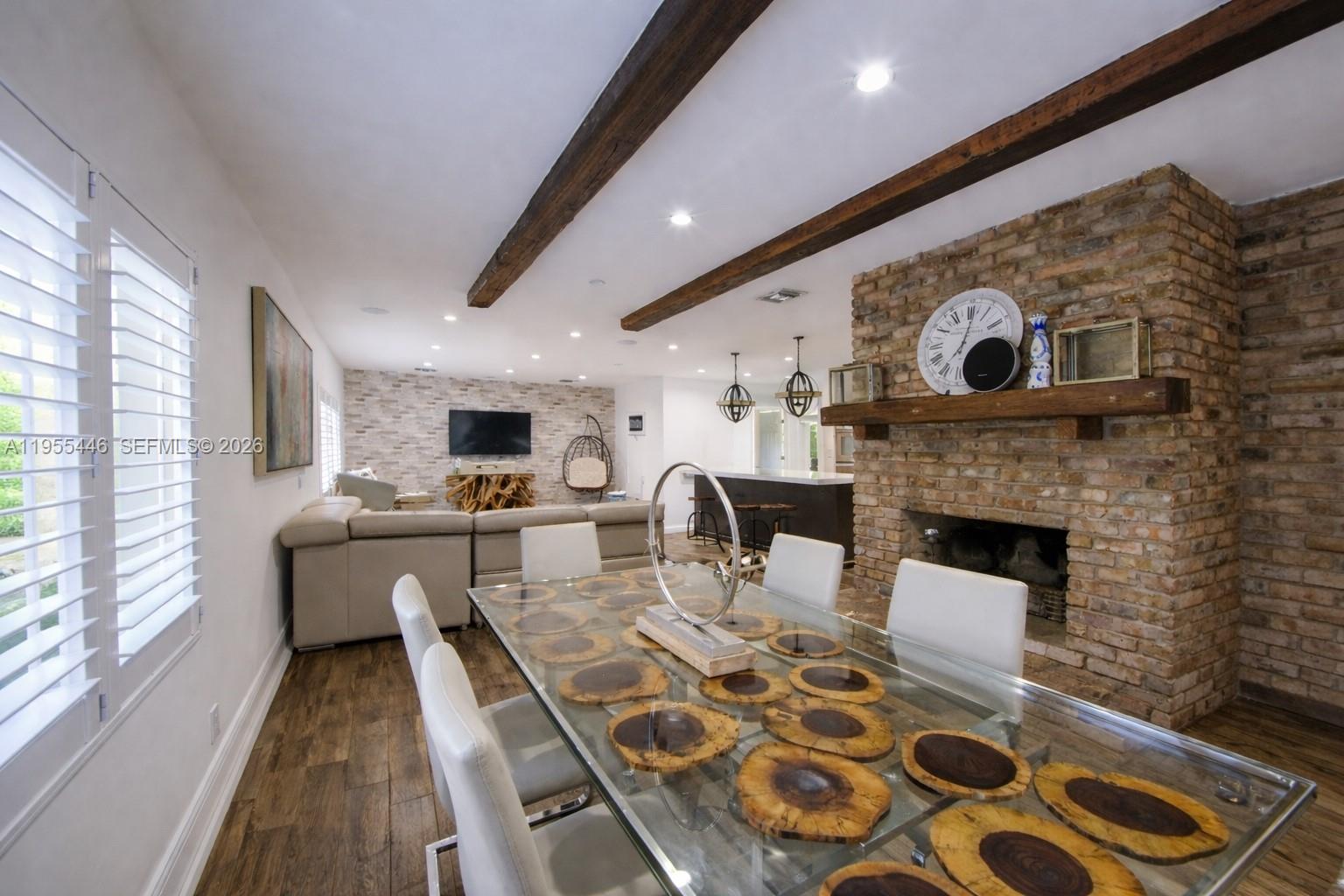 241 Southwest 129th Avenue Miami, FL 33184 - Photo 11 of 28 a living room with furniture a flat screen tv and a fireplace