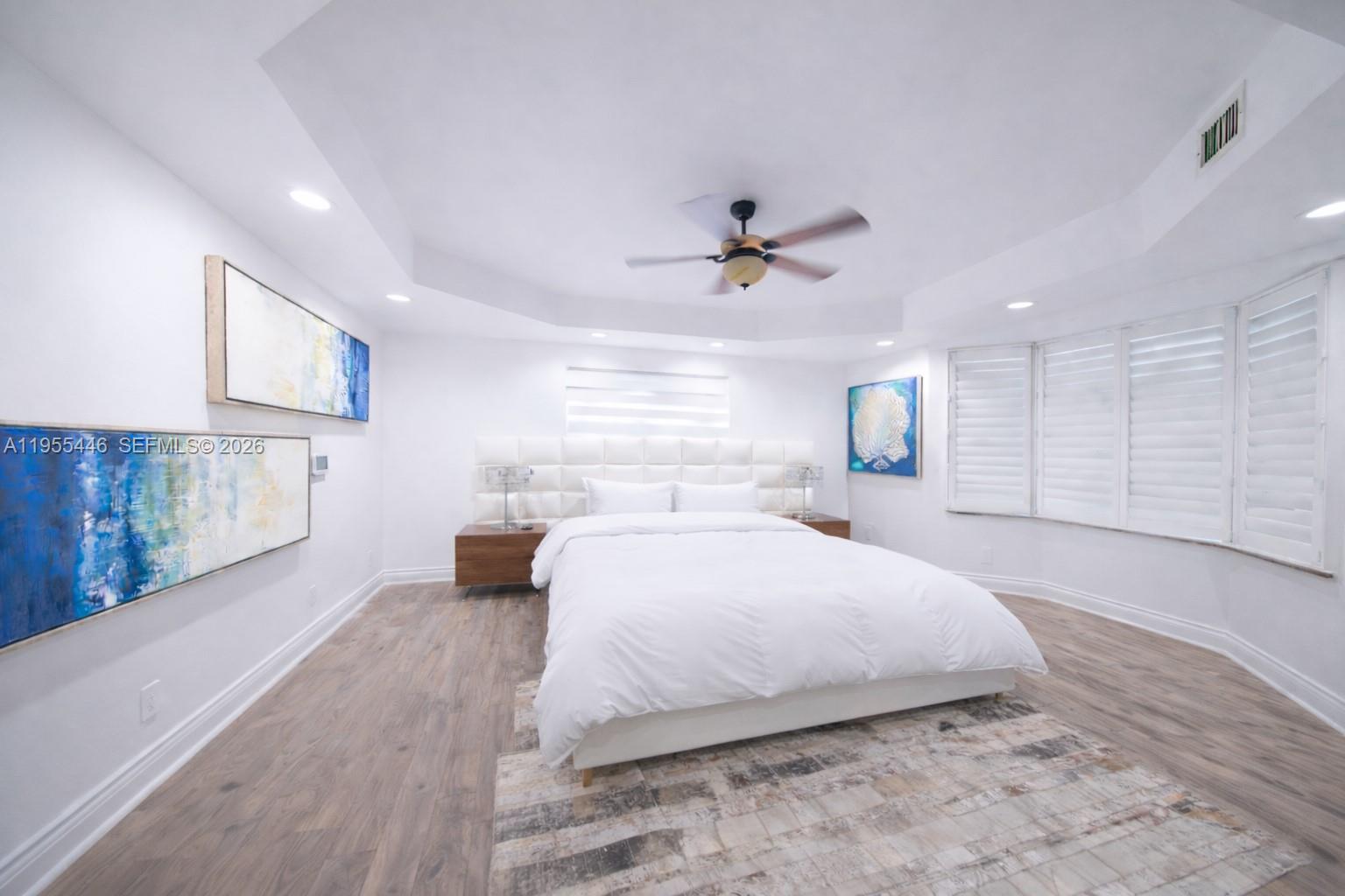 241 Southwest 129th Avenue Miami, FL 33184 - Photo 12 of 28 a spacious bedroom with a large bed and a chandelier
