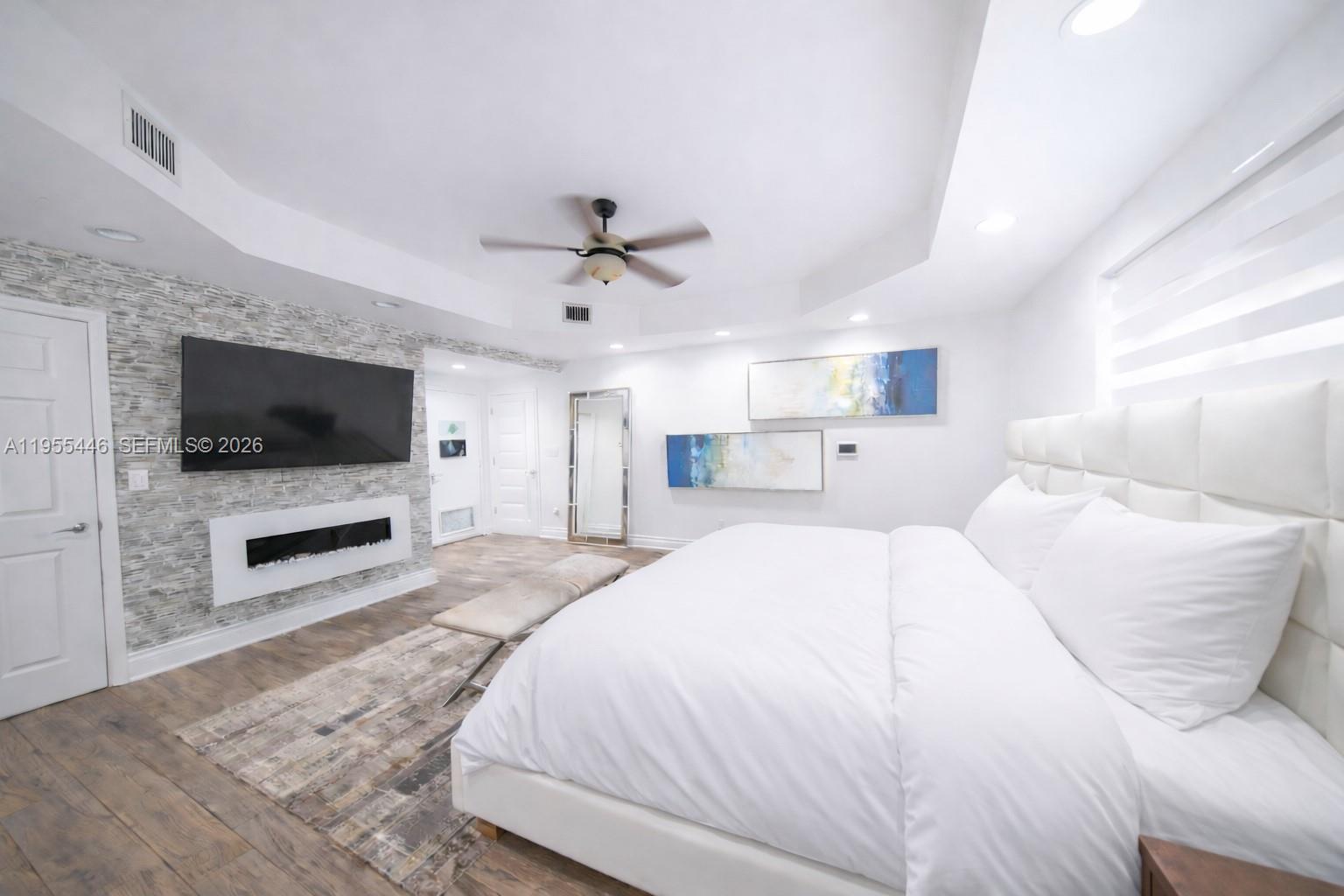 241 Southwest 129th Avenue Miami, FL 33184 - Photo 13 of 28 a spacious bedroom with a large bed and a flat screen tv