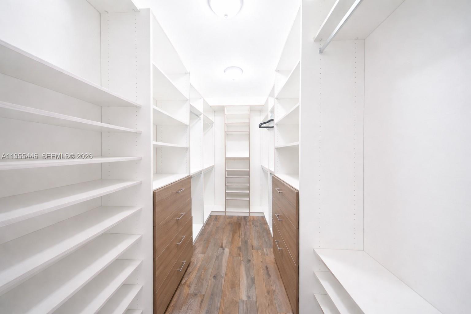 241 Southwest 129th Avenue Miami, FL 33184 - Photo 14 of 28 a view of walk in closet with empty racks