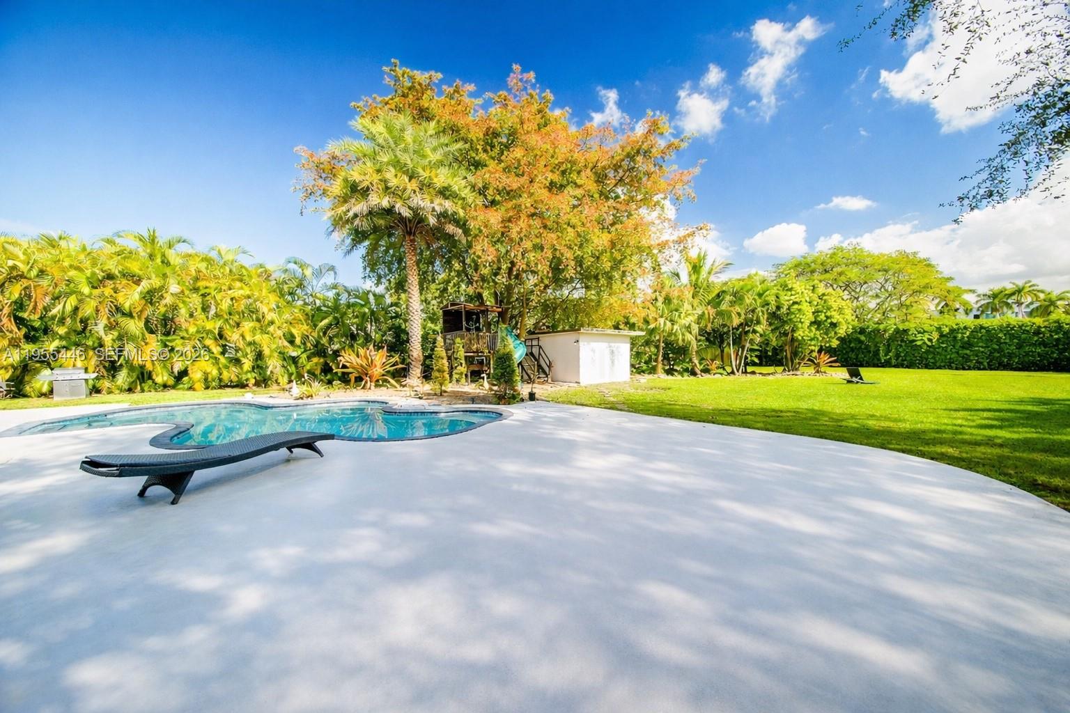 241 Southwest 129th Avenue Miami, FL 33184 - Photo 20 of 28 a view of a backyard with swimming pool