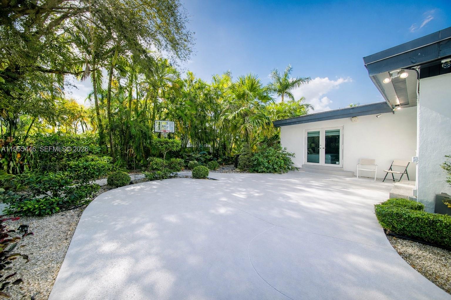 241 Southwest 129th Avenue Miami, FL 33184 - Photo 21 of 28 a view of a house with a yard and potted plants