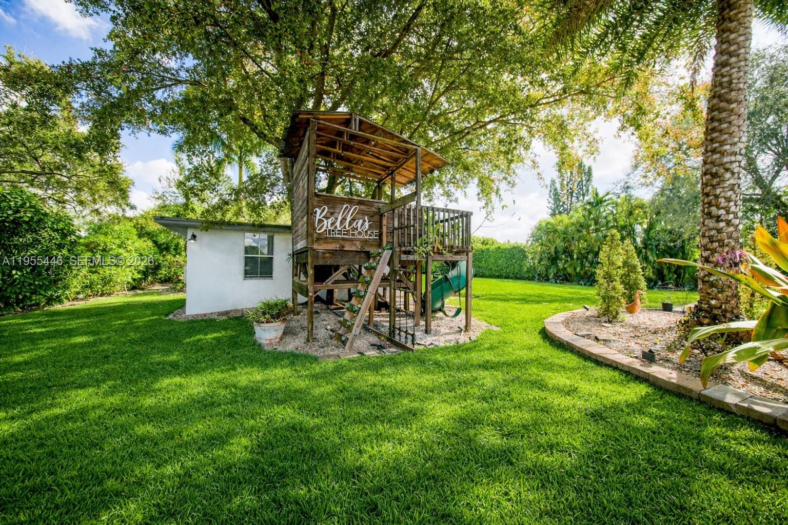 241 Southwest 129th Avenue Miami, FL 33184 - Photo 22 of 28 a view of a chair and table in backyard of the house