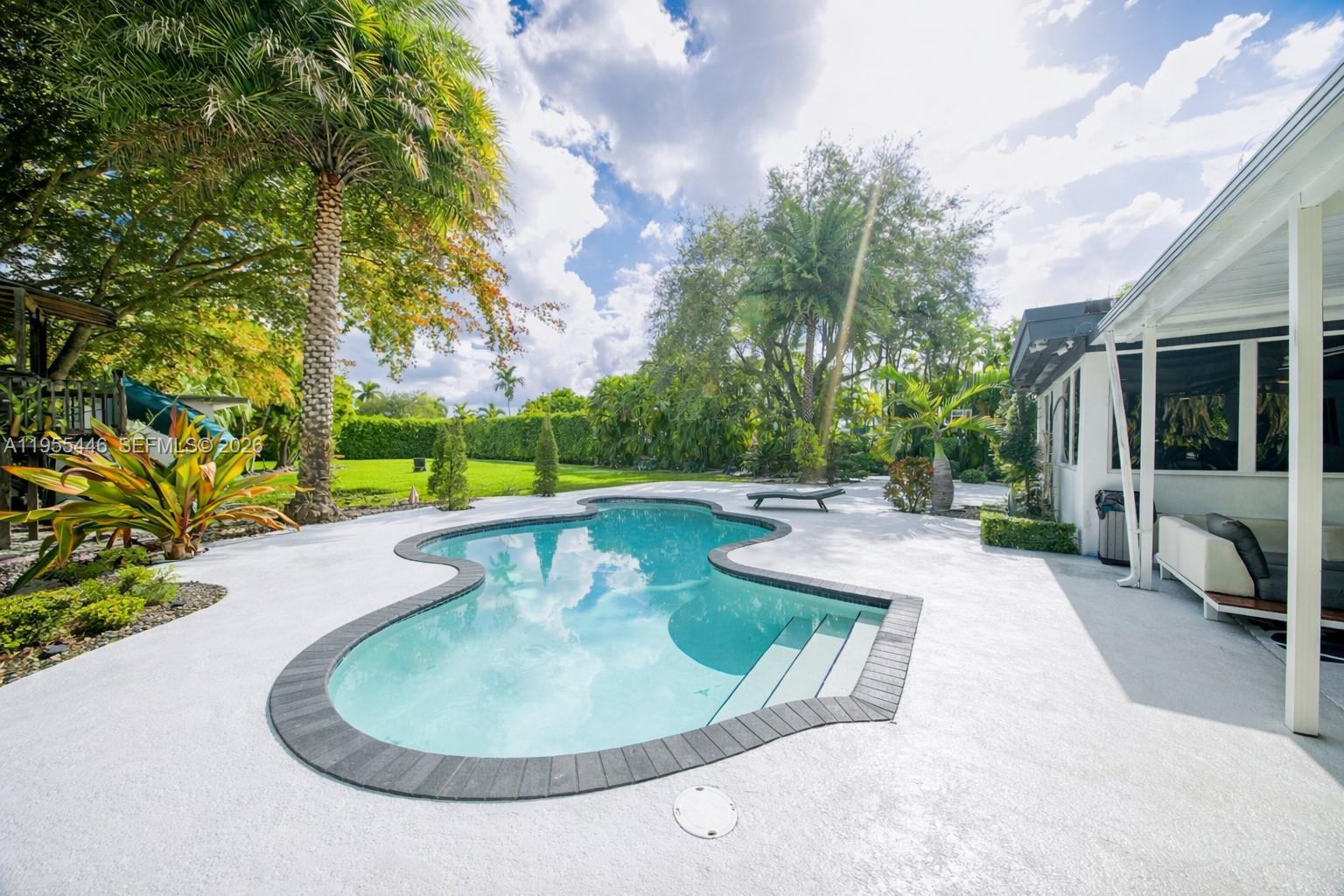 241 Southwest 129th Avenue Miami, FL 33184 - Photo 24 of 28 a view of a swimming pool with a patio