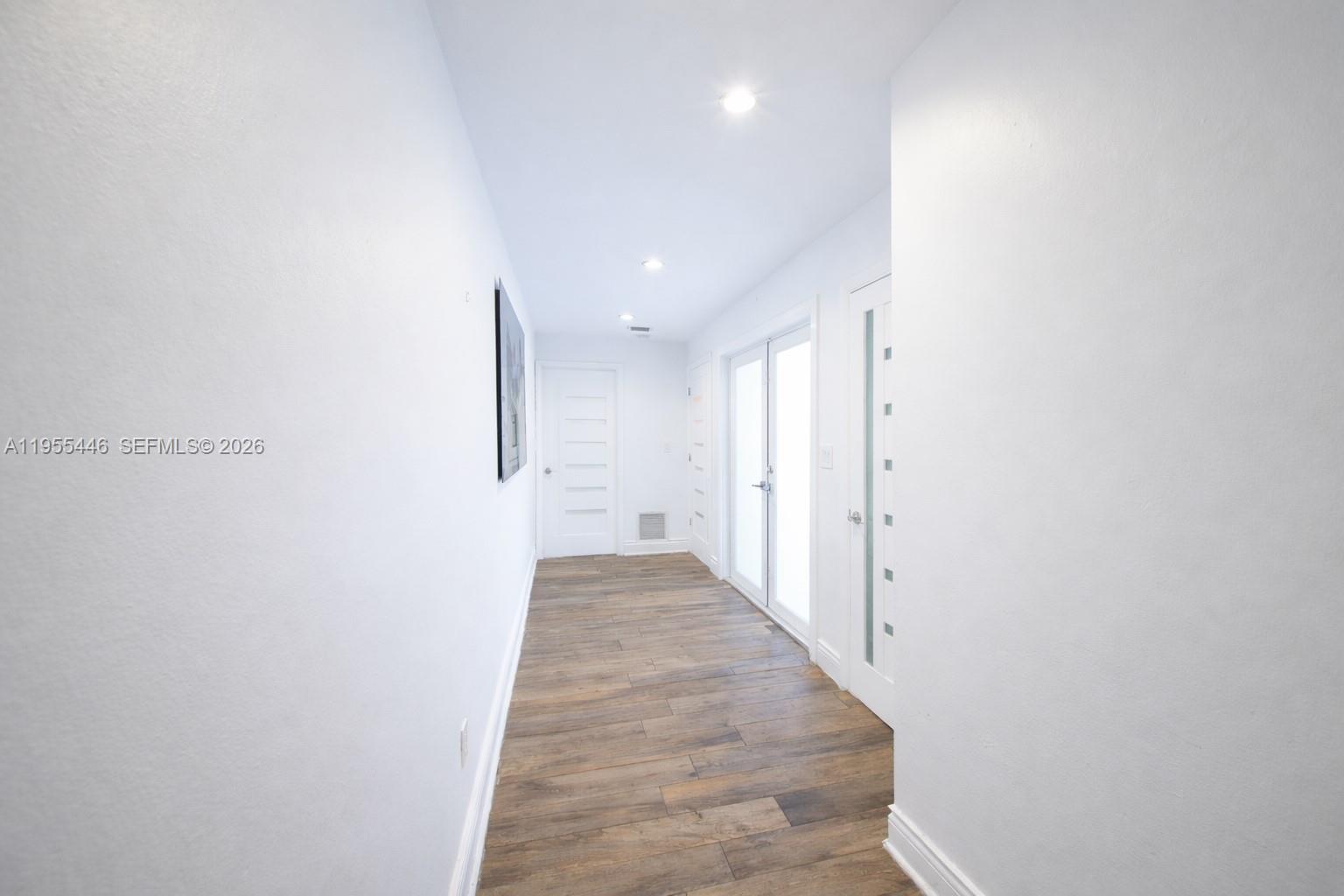 241 Southwest 129th Avenue Miami, FL 33184 - Photo 4 of 28 a view of a hallway with wooden floor