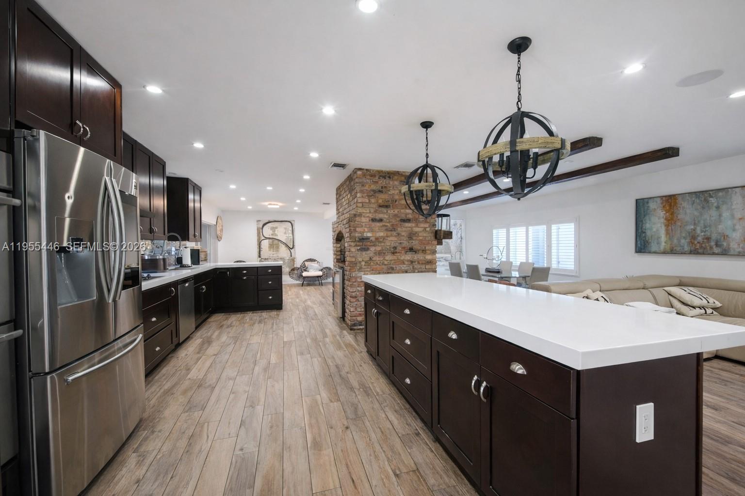 241 Southwest 129th Avenue Miami, FL 33184 - Photo 9 of 28 a kitchen with counter top space cabinets and stainless steel appliances