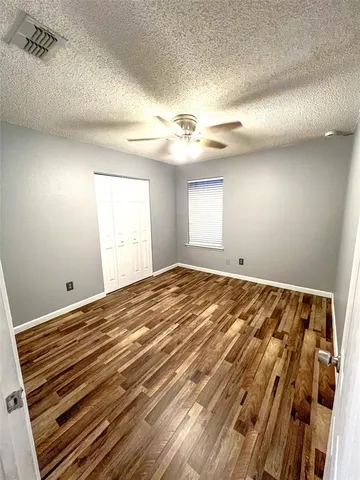 a view of a room with wooden floor