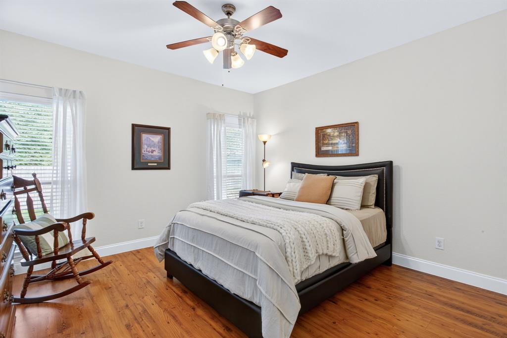 5069 Britton Ridge Lane Fort Worth, TX 76179 - Photo 16 of 32 Primary bedroom with more fresh paint, hard flooring, and a ceiling fan.