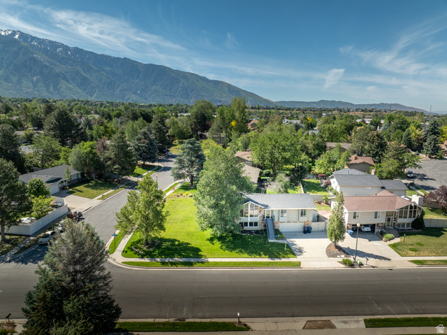 2088 Falcon Way Sandy, UT 84093 - Photo 37 of 46 Single-story residence set on a manicured lawn with mature trees and mountain scenery