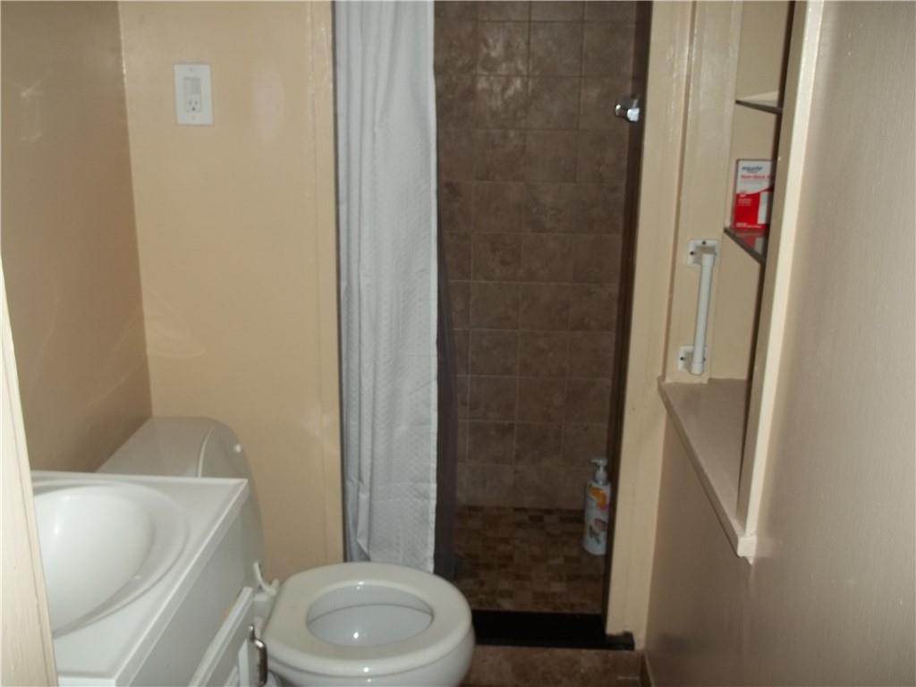 402 McCoy Road McKees Rocks, PA 15136 - Photo 7 of 20 a bathroom with a toilet and shower