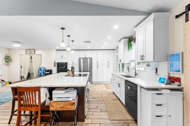 a large kitchen with a table and chairs