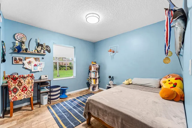 a bedroom with furniture and a window