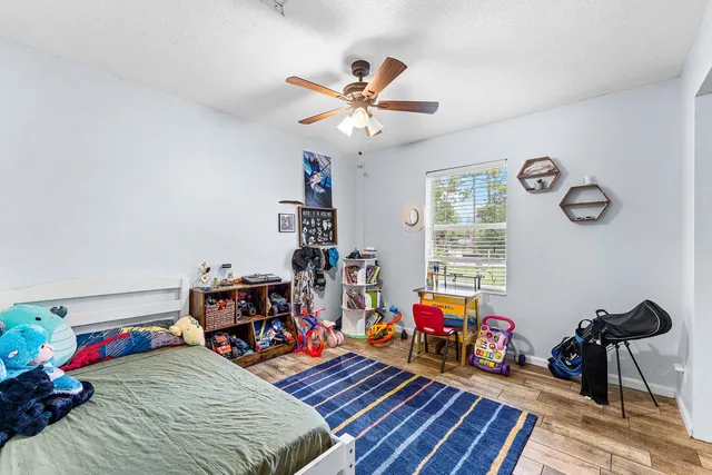 a view of a workspace with furniture gym equipment and a window